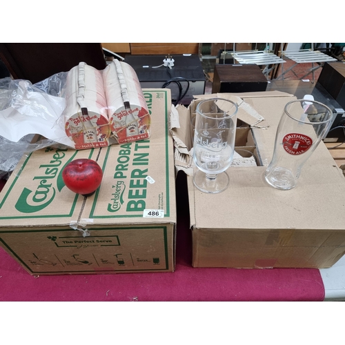 486 - A box of 24 brand new Smithwicks pint glasses, 24 Carlsberg pint glasses and two packets of Malibu b... 