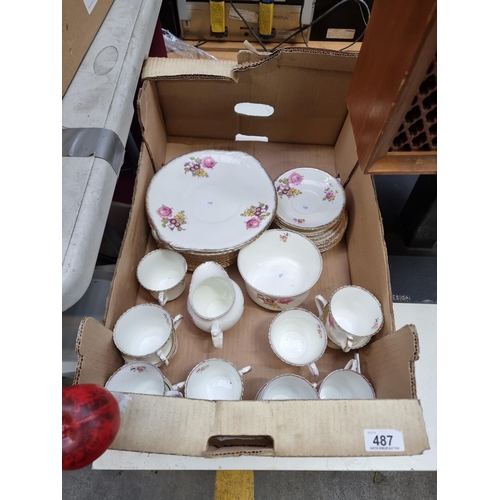 487 - A very pretty large tea service consisting of cream jug, sandwich plates, cups and saucers all with ... 