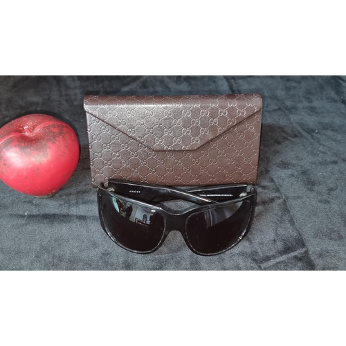 506 - A pair of Gucci women's designer crystal logo oversized sunglasses in black. Comes with brown leathe... 