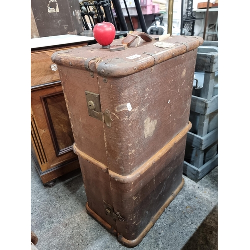 810 - A large early 20th century travel trunk with wooden banding, brass locks and leather handles. Featur... 