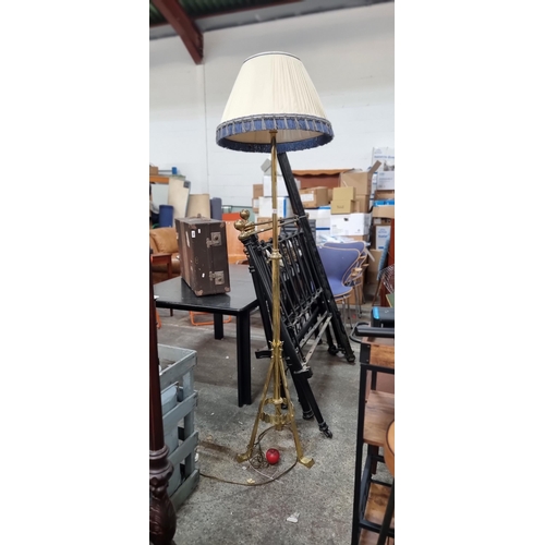 817 - Star Lot : A highly impressive tall brass floor standing lamp featuring a tripod base and cream shad... 