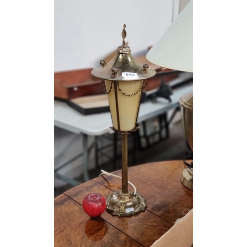 834 - A fabulous  brass table lamp featuring a column stem and floral base in the style of a street lamp.