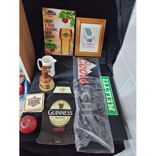 909 - A box containing pub items including a Bell's scotch whiskey  bell, a Bushmills branded whiskey jug,... 