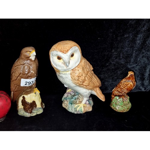 293 - Three ceramic raptor figurines including a stunning barn owl, a Royal Doulton Whyte & Mackay Scotch ... 