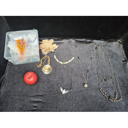 1005 - A box containing an assortment of vintage costume jewellery including necklaces and bracelets. Appro... 