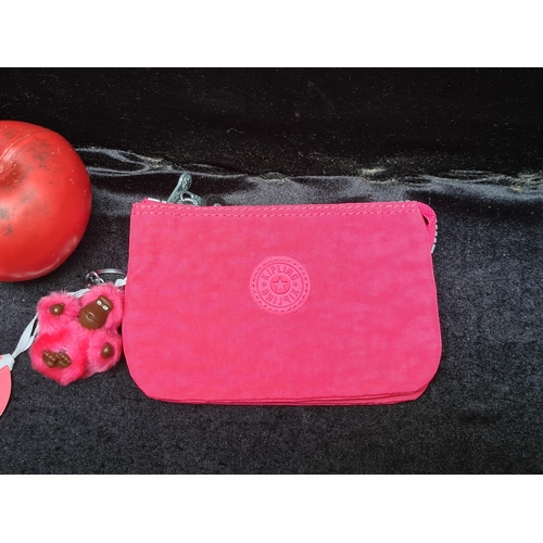 1020 - A brand new Kipling coin purse in fuchsia pink retaining original tags.