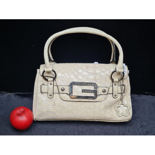 1022 - A stylish ladies Guess designer handbag in a cream leather scale finish.