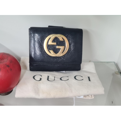 527 - Star Lot : A 2000s Gucci interlocking logo black Tri-Folder Italian leather wallet. Features compart... 