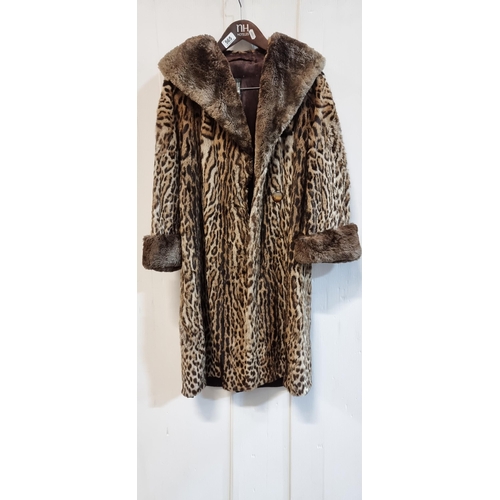 565 - Star Lot : A decadent genuine ocelot fur coat with satin lining and faux fur collar and cuffs. In ve... 