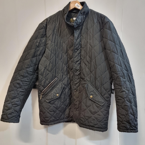 568 - A designer Barbour quilted jacket in black, with corduroy collar. Size Small. Similar RRP of €127.99... 