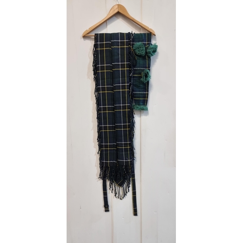 569 - A fantastic Burnett's Scottish kilt including a matching bagpipe bag cover, in a green, navy and yel... 