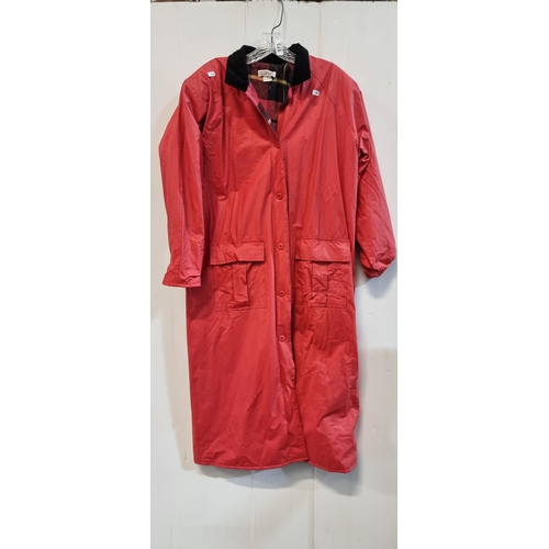 573 - A superb vintage Talbot's full length rain coat in a bright red colour with tartan cotton flannel li... 