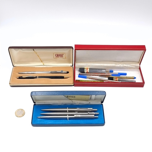 592 - A box containing two cross ballpoint pens, one with insignia also three brushed satin ballpoints, an... 