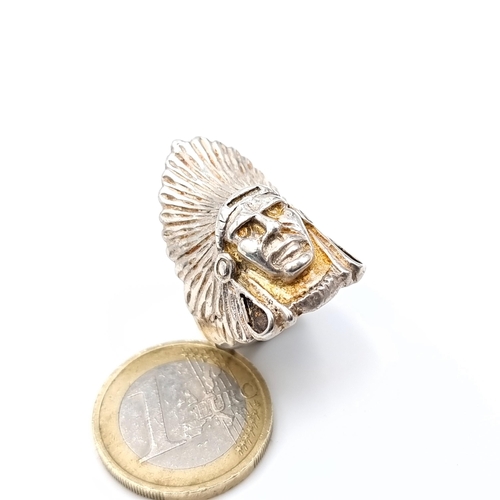 611 - A ring depicting a North American Indian chief, probably silver, size Q, weight 10.9 grams.