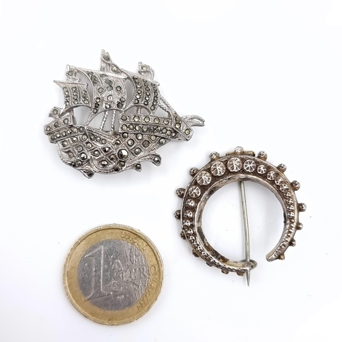 618 - Two brooches including an antique example together with a galleon gem set example , pins intact.