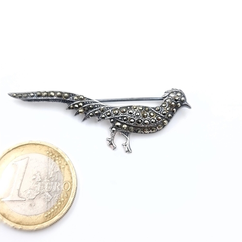 626 - A handsome sterling silver marcasite brooch in the form of a peacock, weight 5.34 grams.