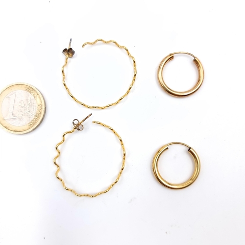 633 - A pair of silver gilt hoop style earrings, suitable for pierced ears, And another pair.  weight 3.18... 