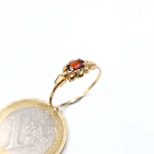 636 - A 9K gold garnet stone ring, size N, weight 0.9 grams, boxed.