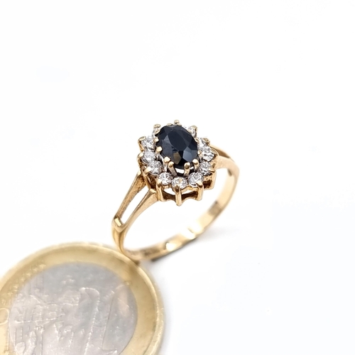 640 - Star Lot : A gem set cluster ring with a sapphire central stone set in 9K gold, size M, weight 1.8 g... 