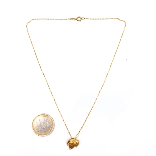 647 - A 9K gold leaf design pendant necklace with chain, length 38cm, weigh 1.95 grams, boxed.