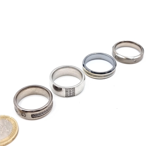 660 - Four gentlemen's rings, two titanium and two tungsten, sizes V x4, total weight 33.79 grams.