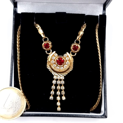 664 - An Egyptian crescent jewelled tasselled pendant and chain, length 44cm, boxed.