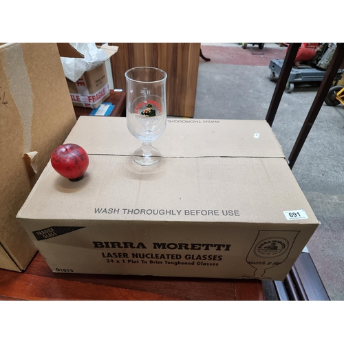 691 - 24 brand new Birra Moretti branded stemmed beer glasses. In original box and packaging.