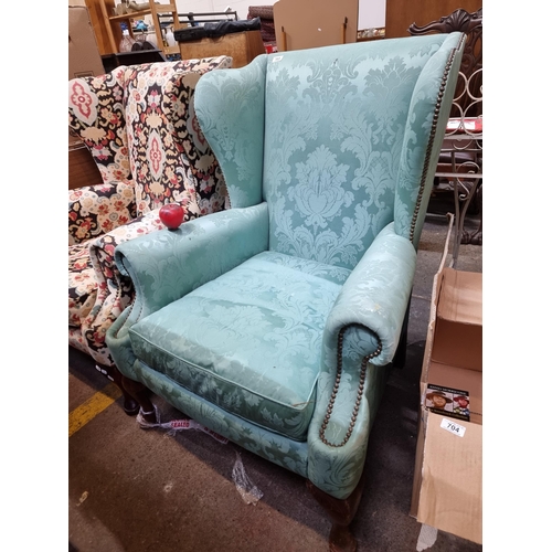 703 - Star Lot : A superb vintage wingback armchair with gorgeous brass stud detailing, upholstered in a v... 