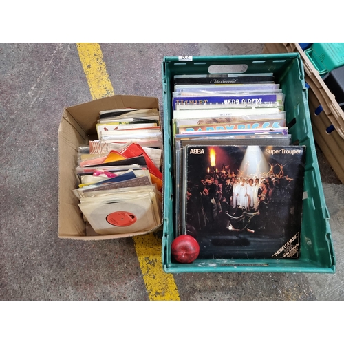 707 - A crate and a box filled with a large number of vintage vinyl records 12' inch and singles with exam... 