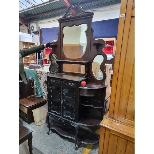 712 - A magnificent antique Victorian mahogany display cabinet featuring two glass doors to front with sin... 