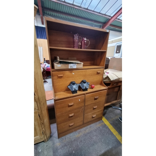 715 - Star Lot : A super mid century modern teak urea bookcase with hinged worktop, two shelves to top and... 