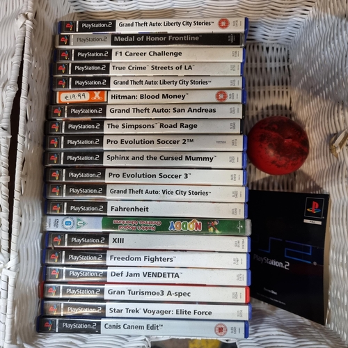 722 - A white wicker box filled with a large number Playstation 2 games including 