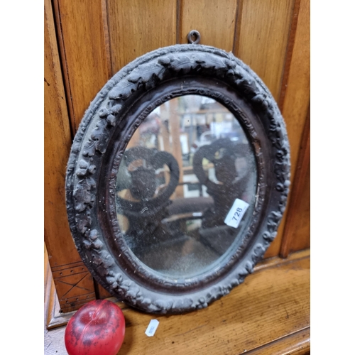 728 - A beautiful neatly sized early 20th century oval wall mirror held in a beautifully moulded frame boa... 