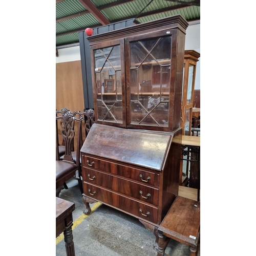 733 - A magnificent 1930s bureau bookcase featuring astra glassed fronted cupboard to top with two shelves... 