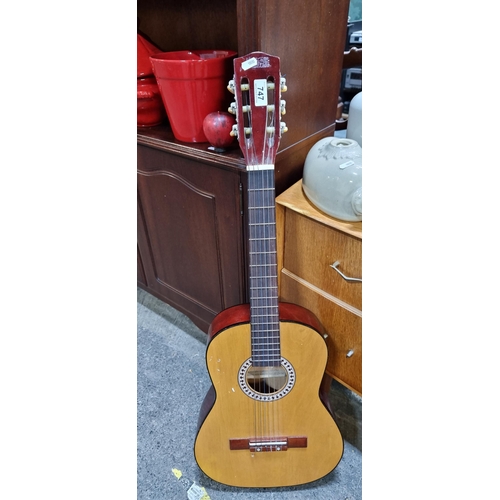 747 - A nice acoustic guitar, with all its strings. 
info brand