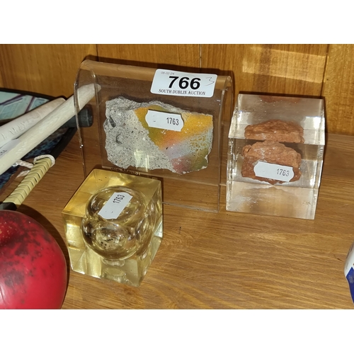 766 - Three interesting items including a commemorative piece of the Berlin wall, dice in a lucite case yo... 