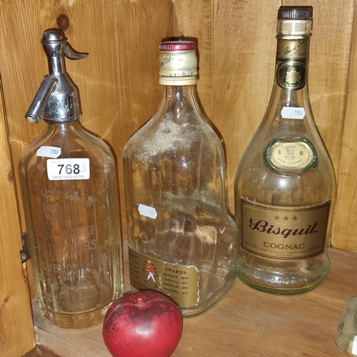 768 - Three items including two very large vintage empty glass alcohol bottles as well as an Irish soda sy... 