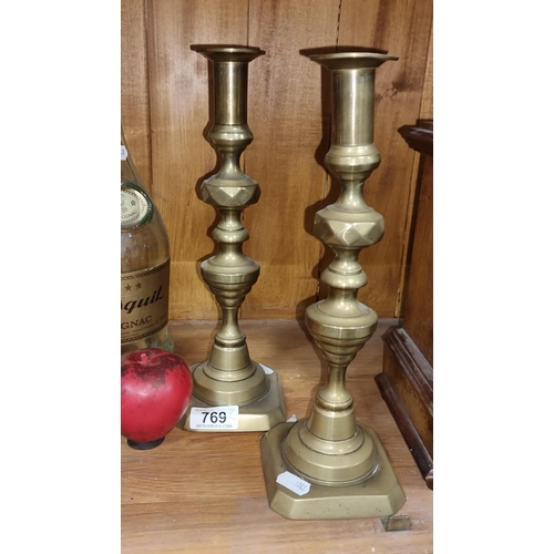 769 - A superb pair of Antique diamond patternsed tall brass candlesticks.