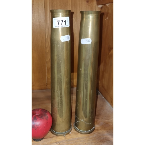 771 - A pair of tall brass artillery shell cases.