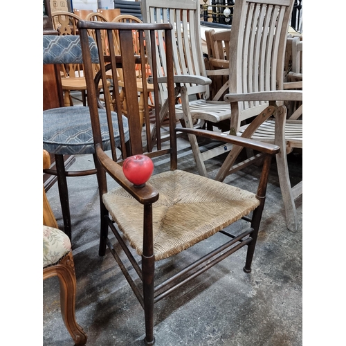 789 - Star lot : A beautiful early antique low elbow chair featuring spindled back and wicker seat. This i... 