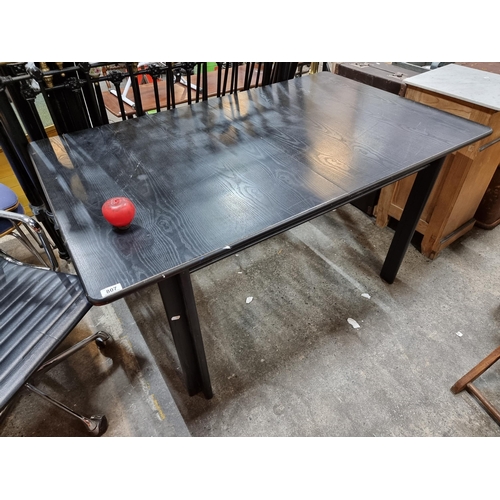 807 - A large black ashe wooden dining table.