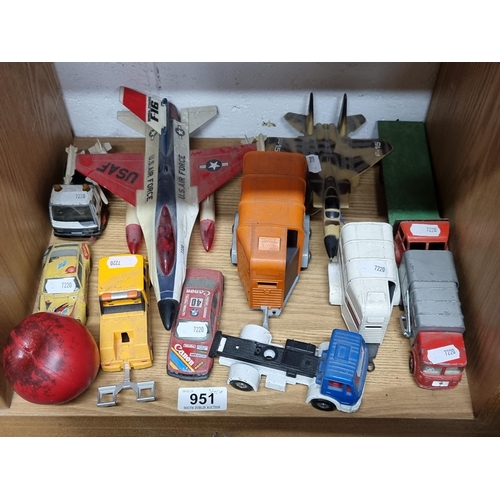 951 - A wonderful collection of vintage tin toys including trucks, cars and two fighter jets.