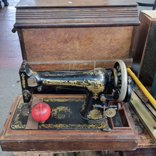 988 - A handsome antique Singer sewing machine, looks great in the origin square oak travel case.