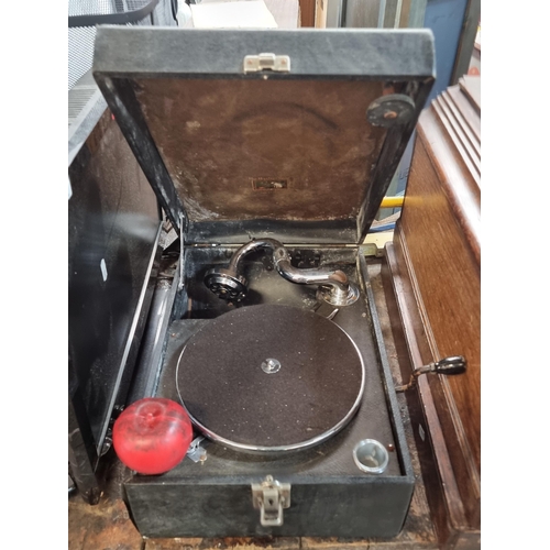 989 - A good mobile gramophone with case and wind up handle.