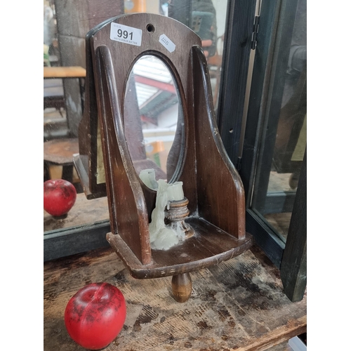 991 - A handsome antique Mirror with a candle looks to have a handle on the bottom, pre electric way to li... 