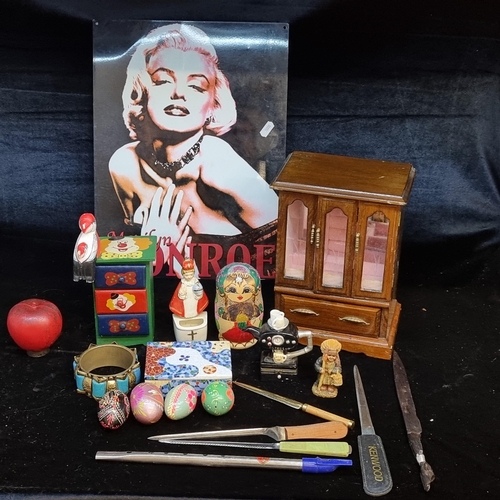 153 - An interesting  box,  including a metal Marily Monroe sign, 5  letter openers, a jewellery box, pain... 