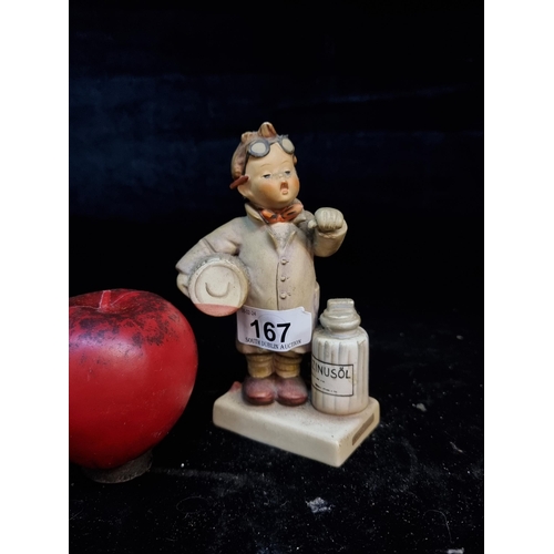 167 - A vintage Hummel figurine number 322 Little pharmacist, depicting a child carrying medicine. jars.