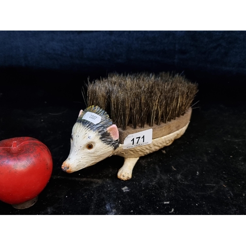 171 - A cast metal and wood hedgehog boot scraper. 