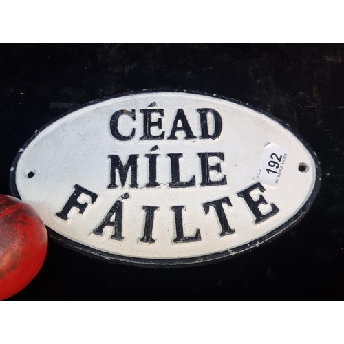 192 - A cast metal white and black sign reading 'Cead Mile Failte'.