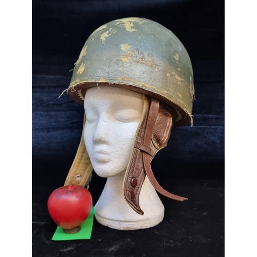 196 - A 1950's Belgian paratrooper helmet complete with leather straps and buckles.